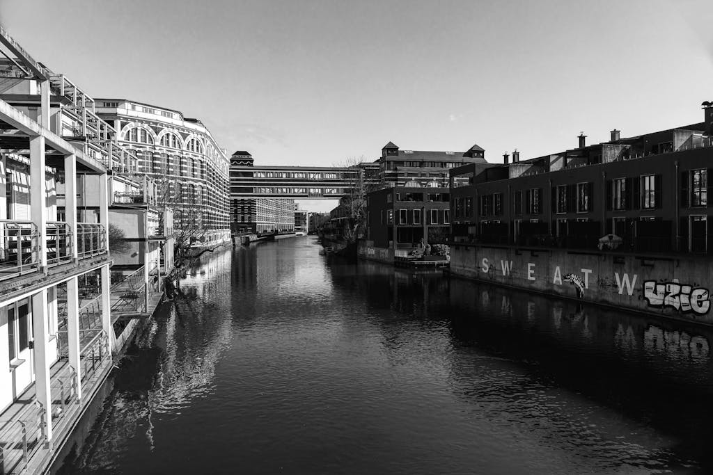 Black and white urban scene of buildings along a canal in Leipzig, Germany.
